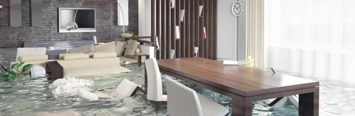 home interior affected by water damage with flooded floors and displaced furniture in Worcester, MA